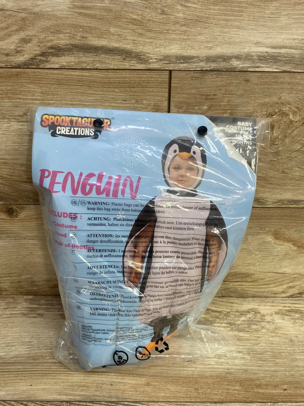 Penguin baby costume for 18-24 months, includes hood and booties, packaged in Spooktacular Creations