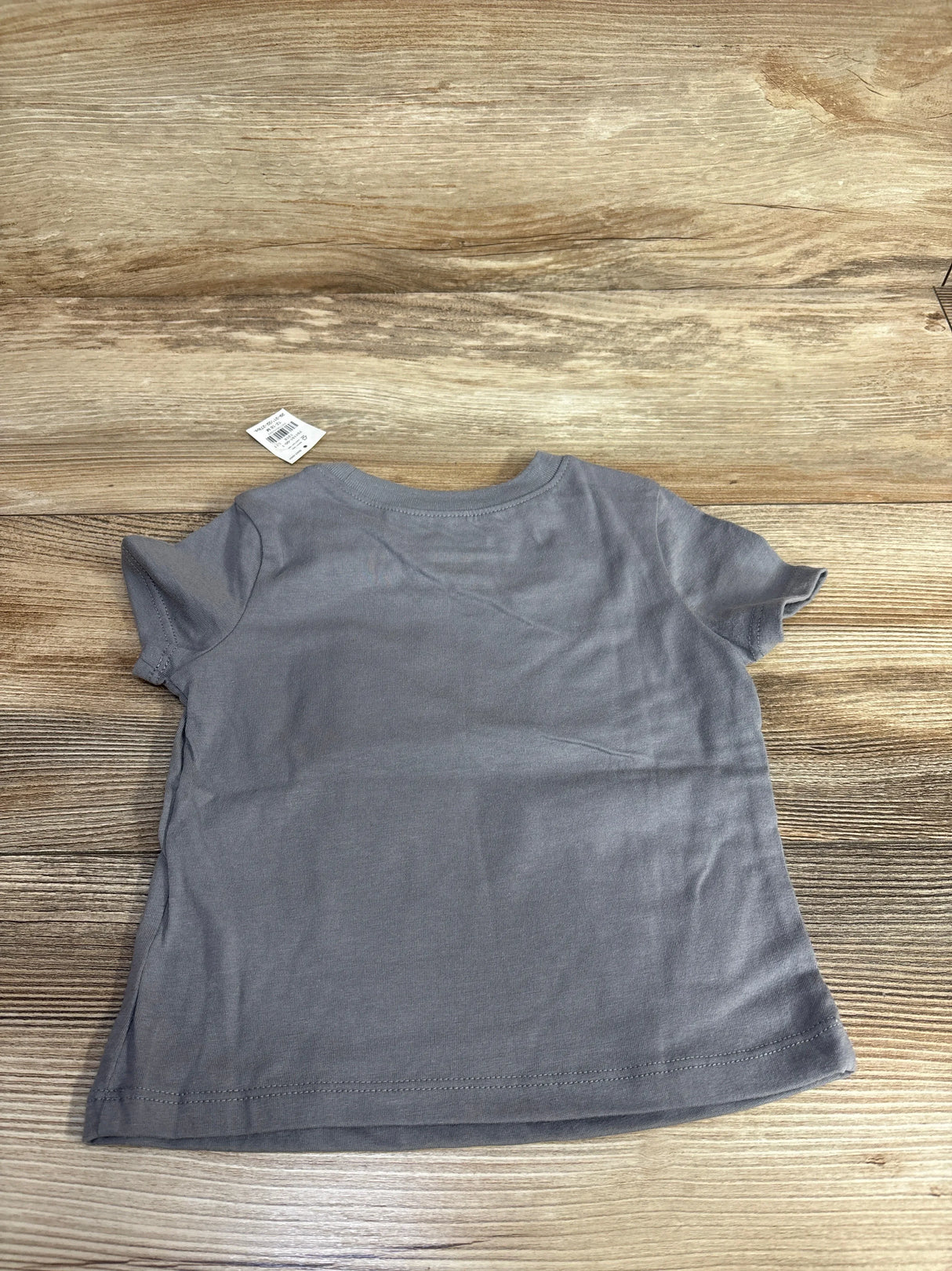 Gray kids short sleeve t-shirt on wood floor, resale children's clothing