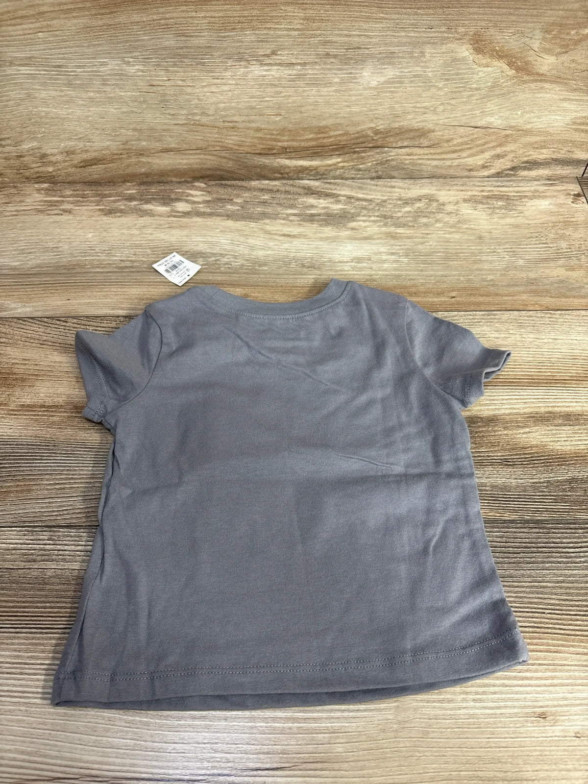Gray kids short sleeve t-shirt on wood floor, resale children's clothing