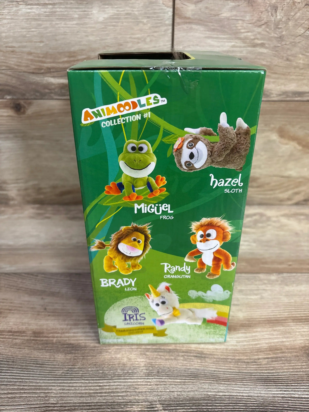 Front of Animoodles Magnetic Plush Animal Brady Lion box showing Brady and other pictured characters on wood background