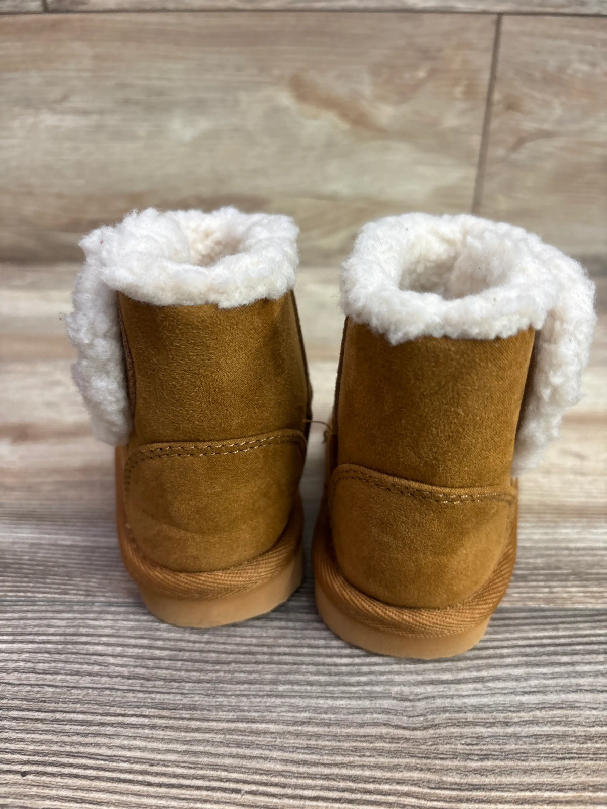 Pair of cognac brown vegan suede cozy boots with white sherpa lining for toddlers.