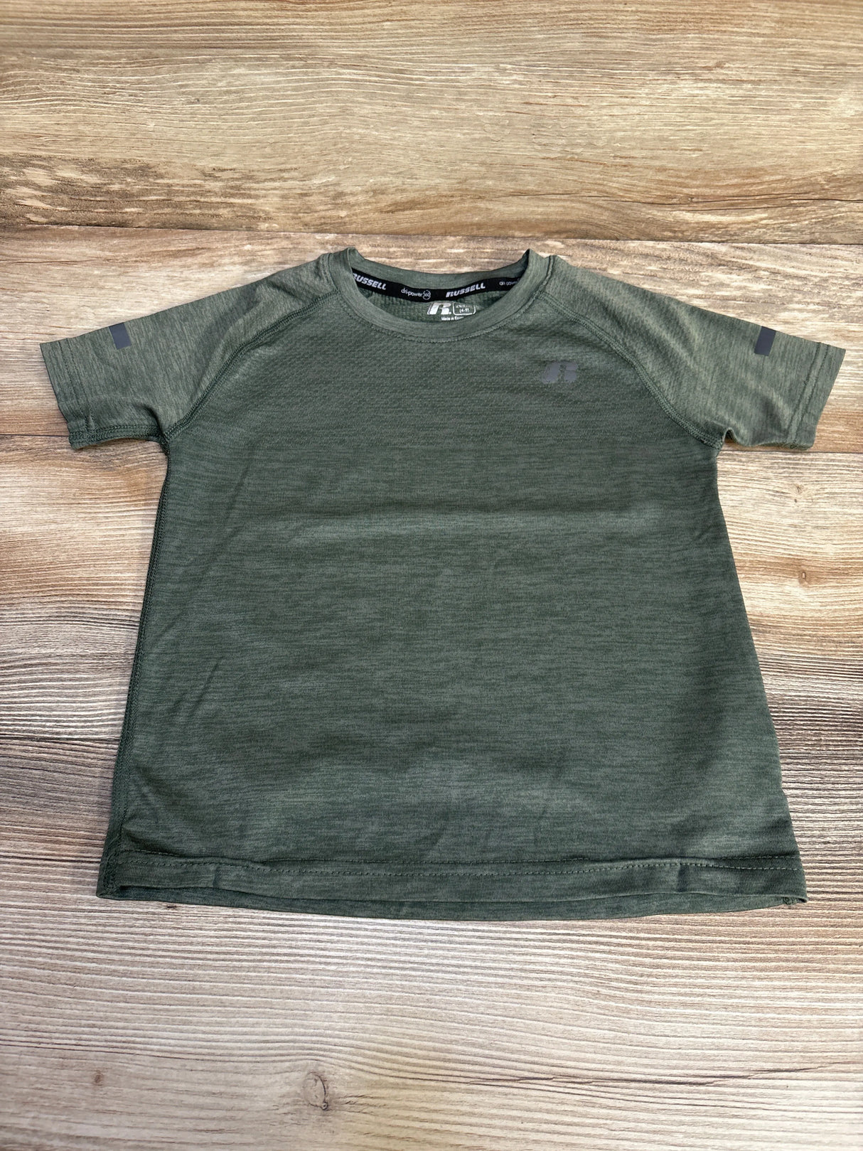 Olive green Russell athletic t-shirt on wood background, short sleeves, simple design