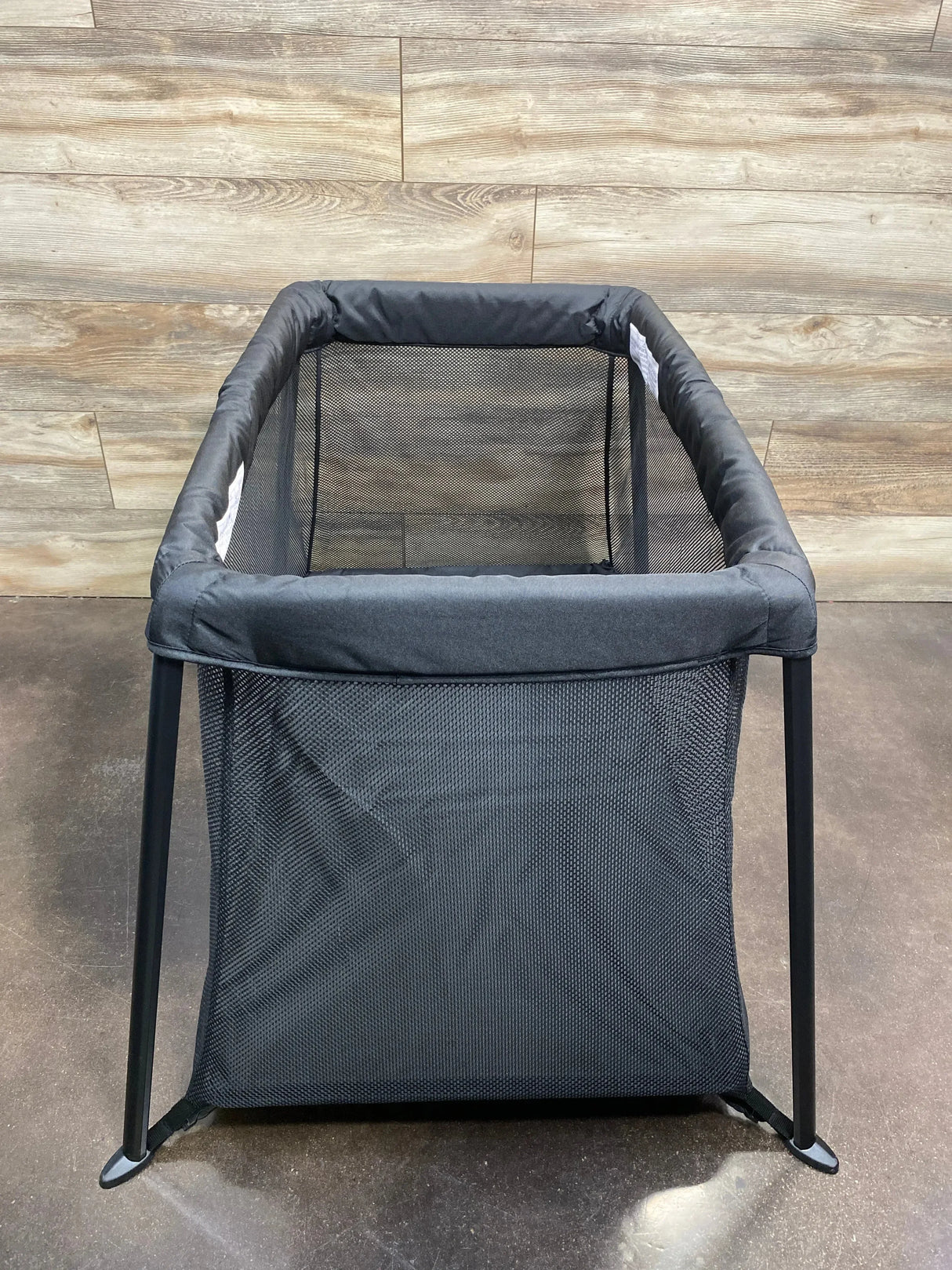 Front view of Dream On Me Travel Light playard in black showing mesh sides and collapsible frame on white background