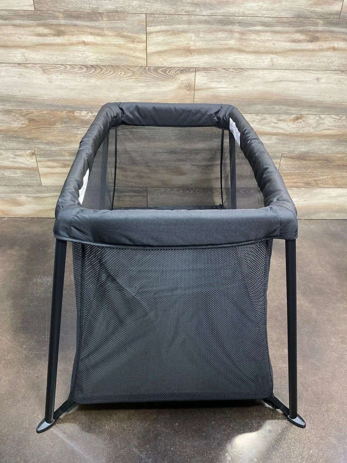 Front view of Dream On Me Travel Light playard in black showing mesh sides and collapsible frame on white background