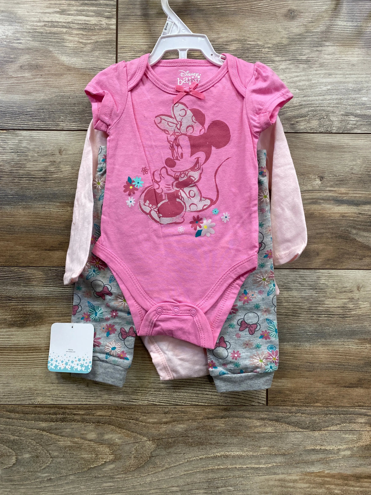 Pink Disney Baby Minnie Mouse onesie outfit with floral pattern, long sleeves and pants