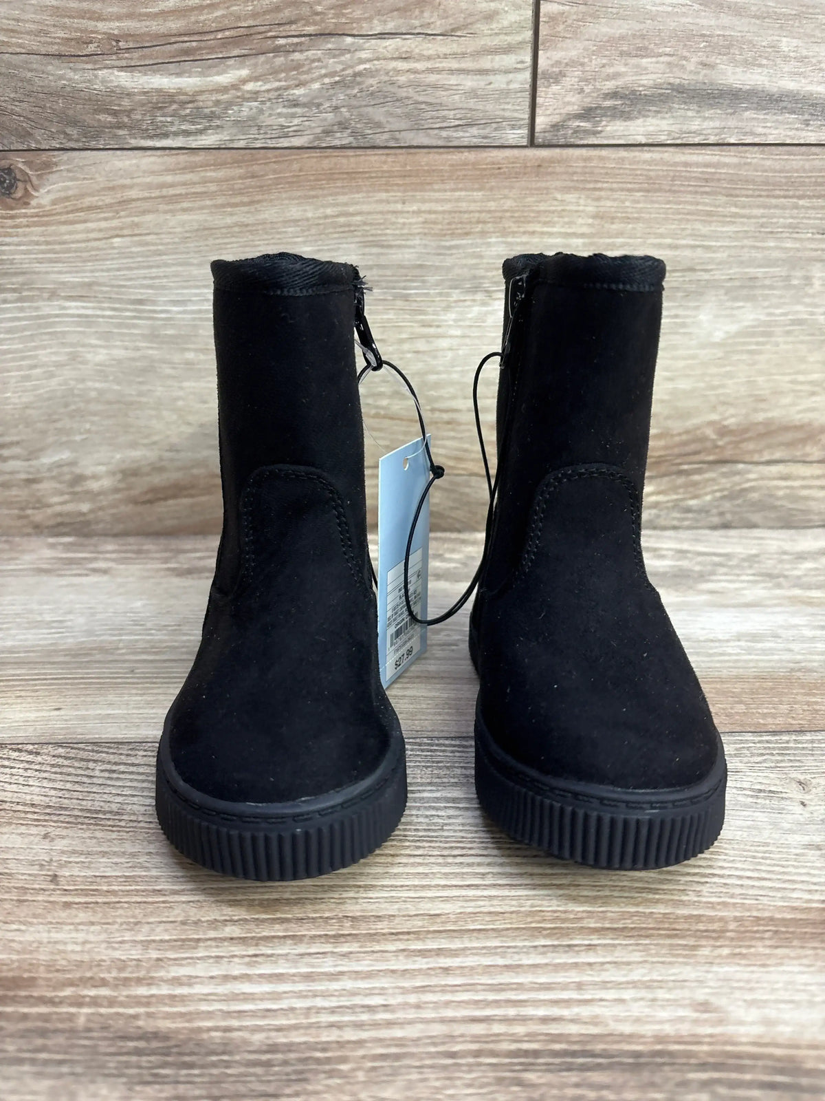 Front view of Cat and Jack Pip Shearling toddler boots in black suede showing side zippers and ribbed sole on wood floor