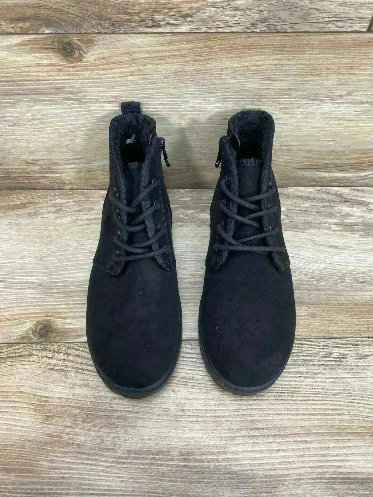 Top-down view of Cat and Jack Ronin kids' black ankle boots, size 2Y, showing lace-up front and side zipper on wood floor