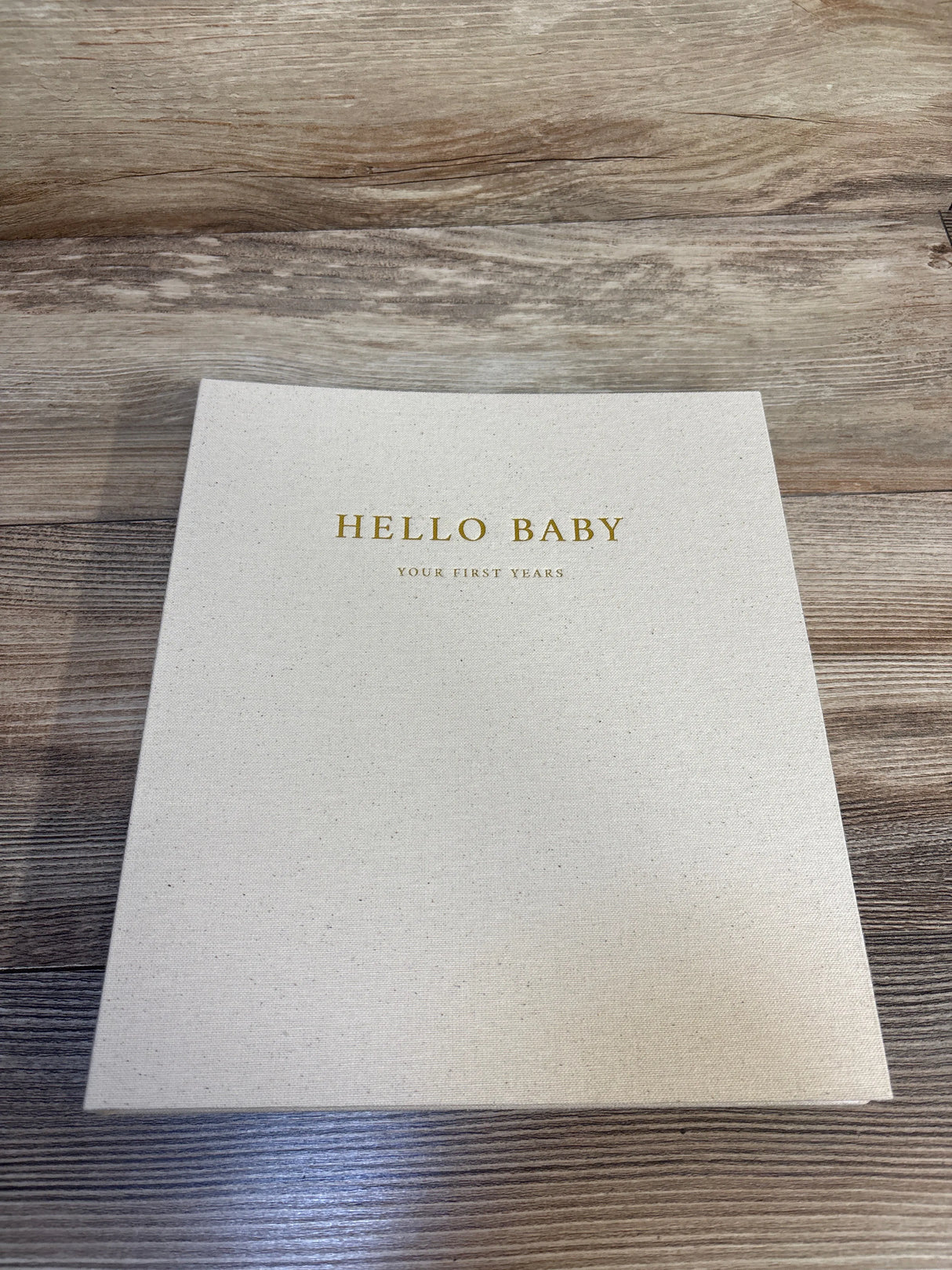 Hello Baby first years keepsake book on wood surface