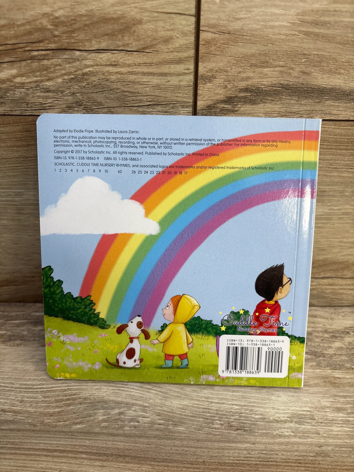 Children and dog in grassy field with rainbow, Cuddle Time Nursery Rhymes book back cover