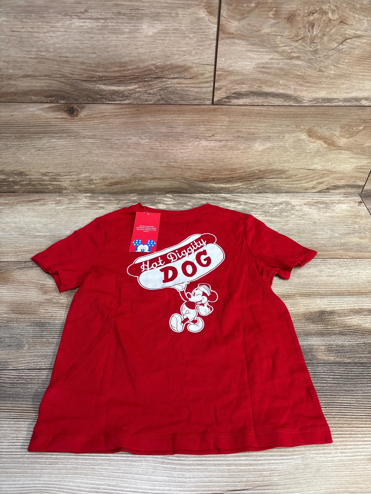 Front view of red Old Navy Disney toddler T-shirt showcasing a Hot Diggity Dog Mickey Mouse graphic on a wood background