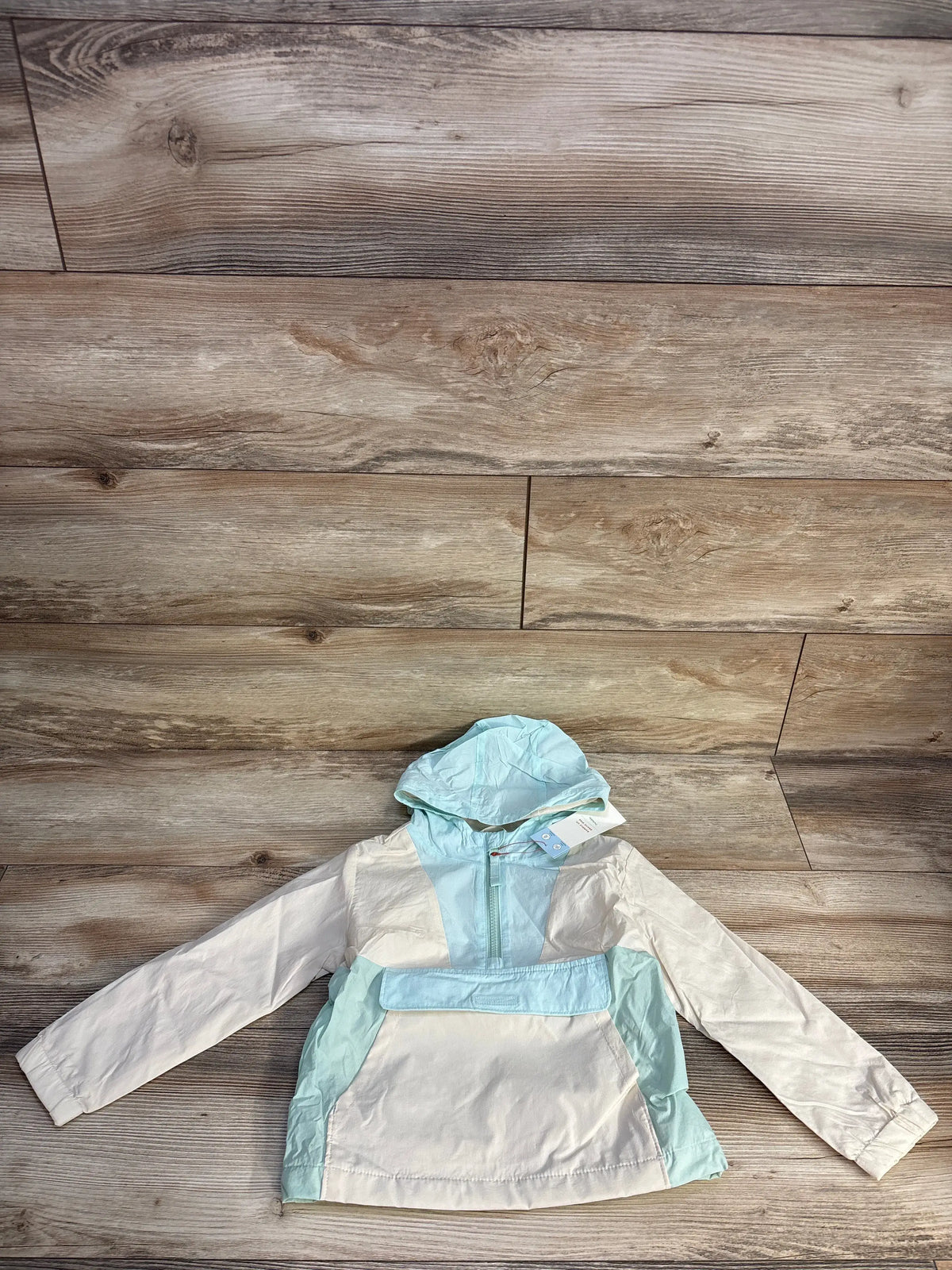Front view of Cat and Jack colorblock hooded windbreaker showing cream and blue panels, half zip, and pouch pocket