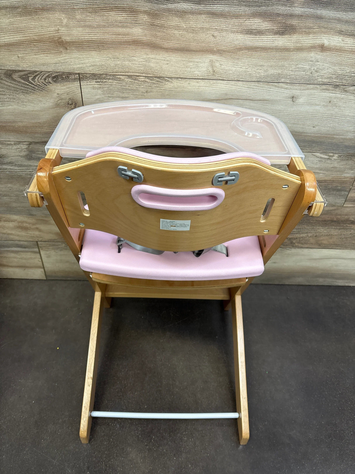 Wooden high chair with pink seat and detachable tray for babies or toddlers
