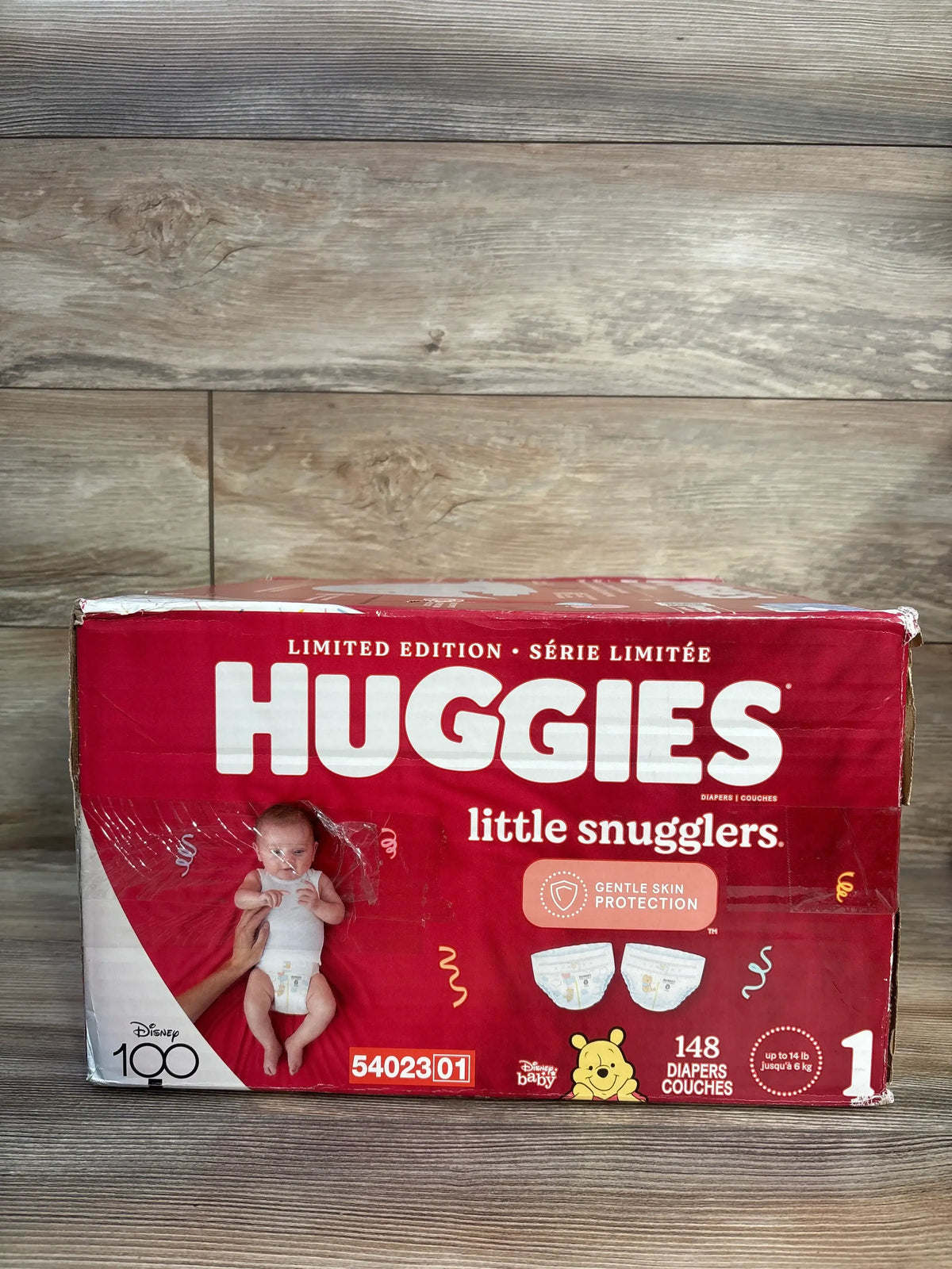 Front view of Huggies Little Snugglers Size 1 diaper box with 148 diapers, gentle skin protection, and limited edition branding
