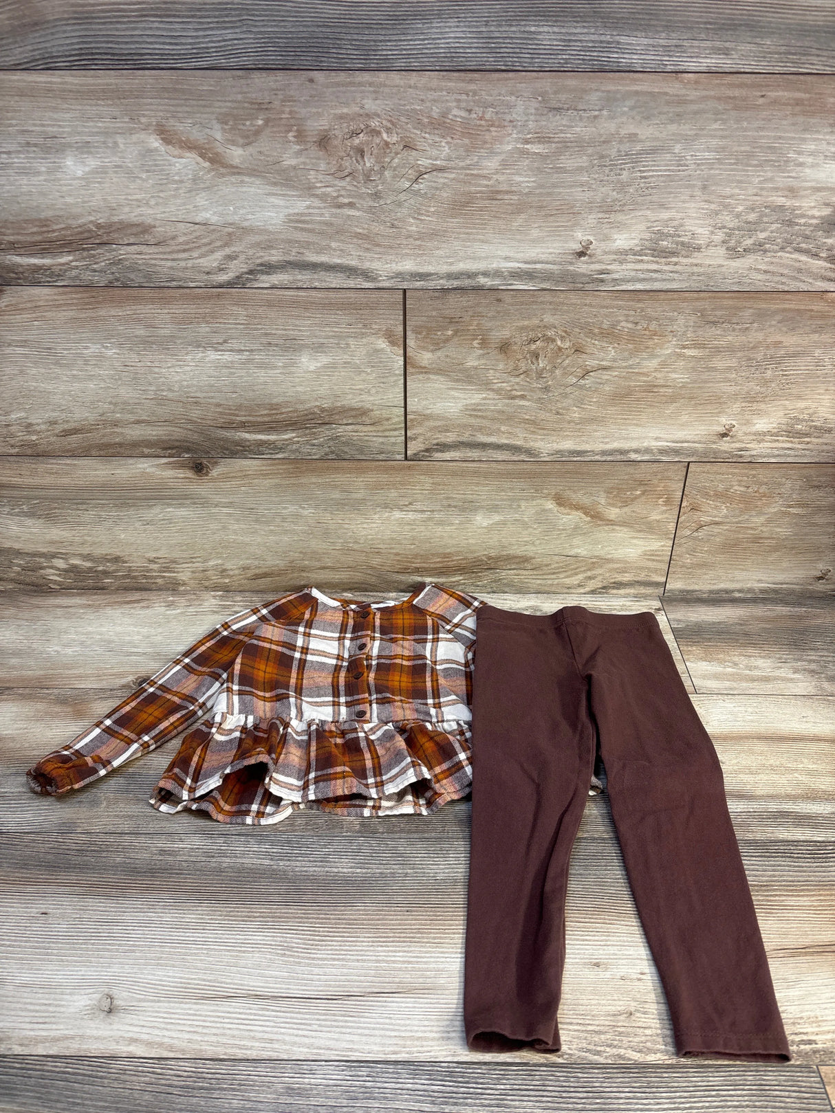 Plaid ruffle top and brown leggings kids outfit on wood floor