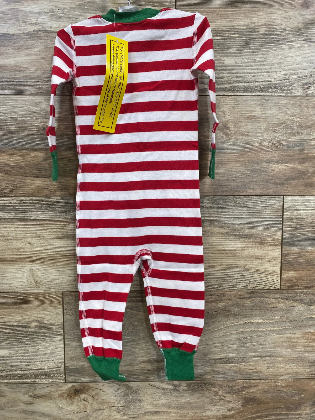 Red and white striped baby footed pajamas with green cuffs, holiday-themed kids sleepwear