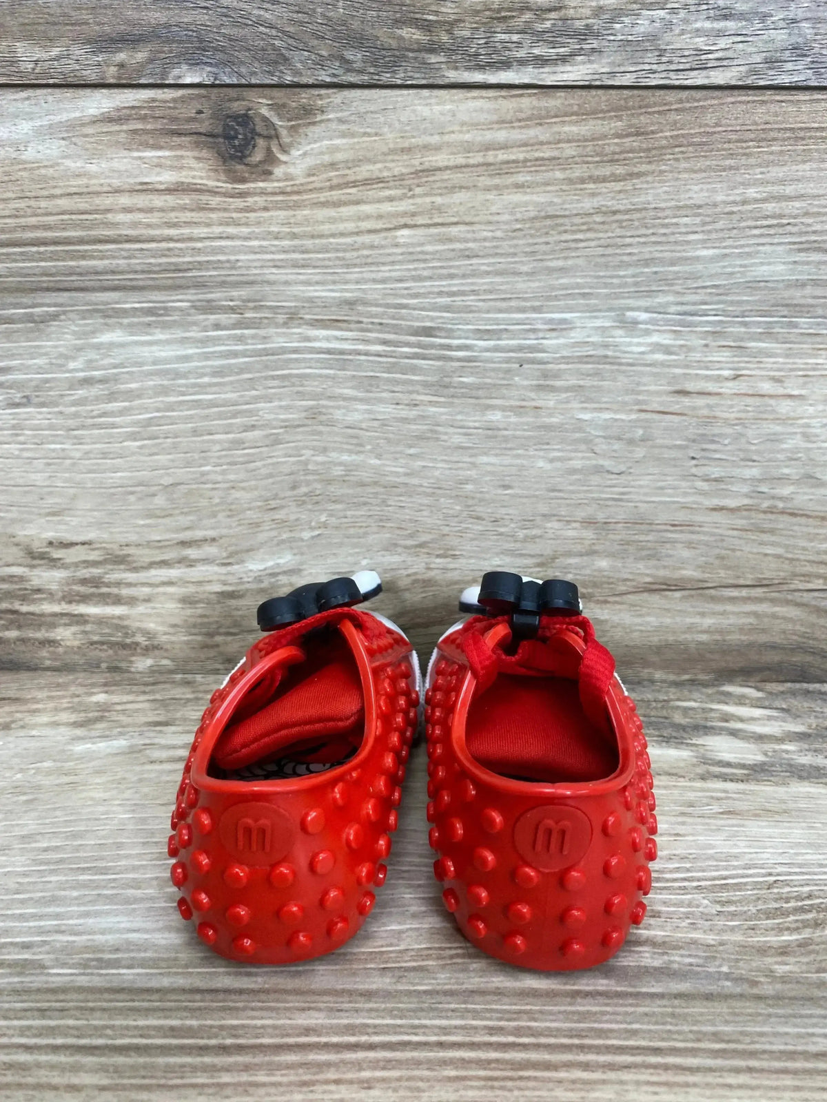 Side view of Mini Melissa Polibolha x Disney red toddler sneaker with bubble-texture upper and Mickey accent