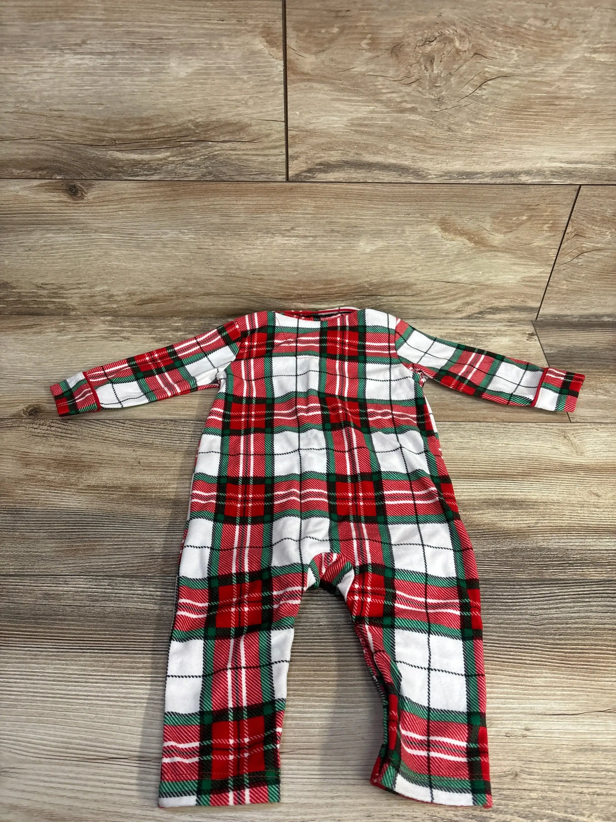 Red green white plaid baby onesie on wood floor, holiday kids clothing