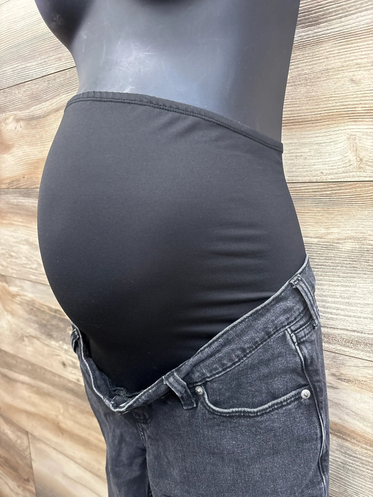 Side view of black Abercrombie ‘90s straight maternity jeans with high-rise belly panel on mannequin