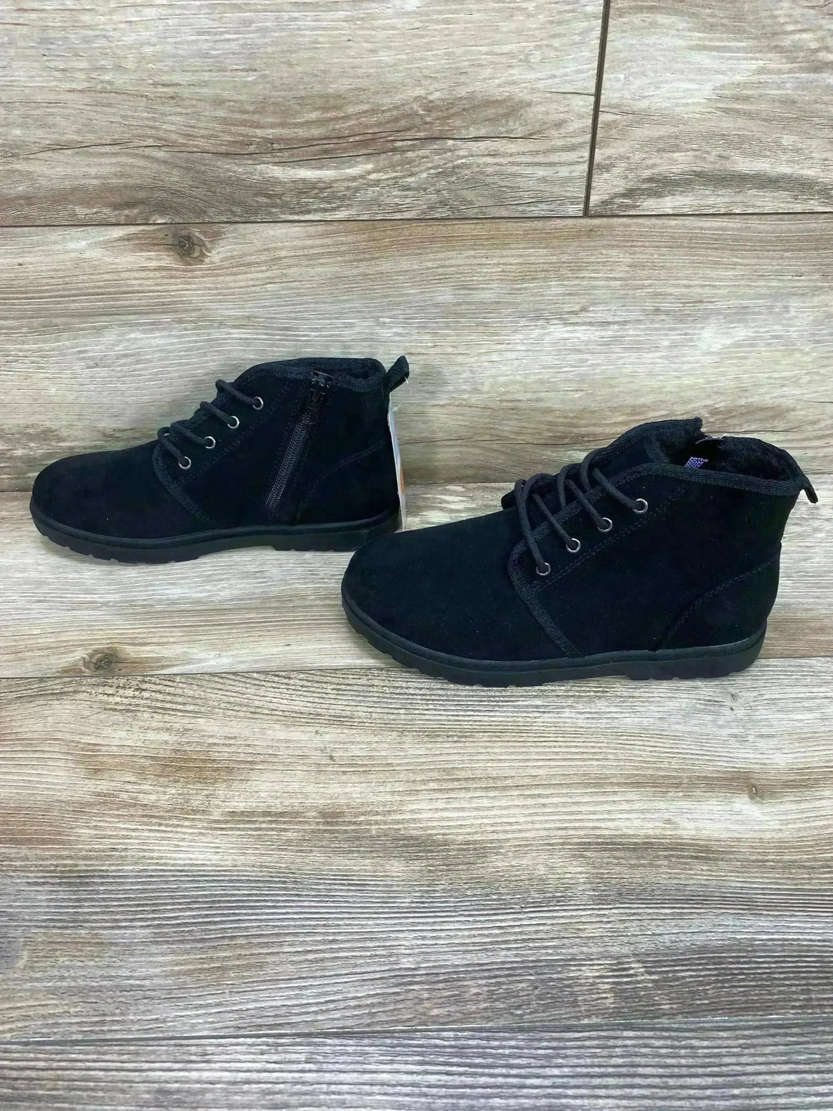 Side view of Cat and Jack Ronin boots showcasing black suede lace-up ankle boots with side zipper on wood plank floor