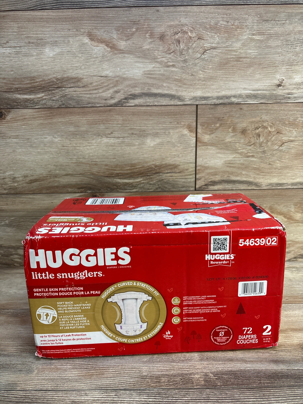 Huggies Little Snugglers size 2 diapers box, 72 count, red packaging on wood floor