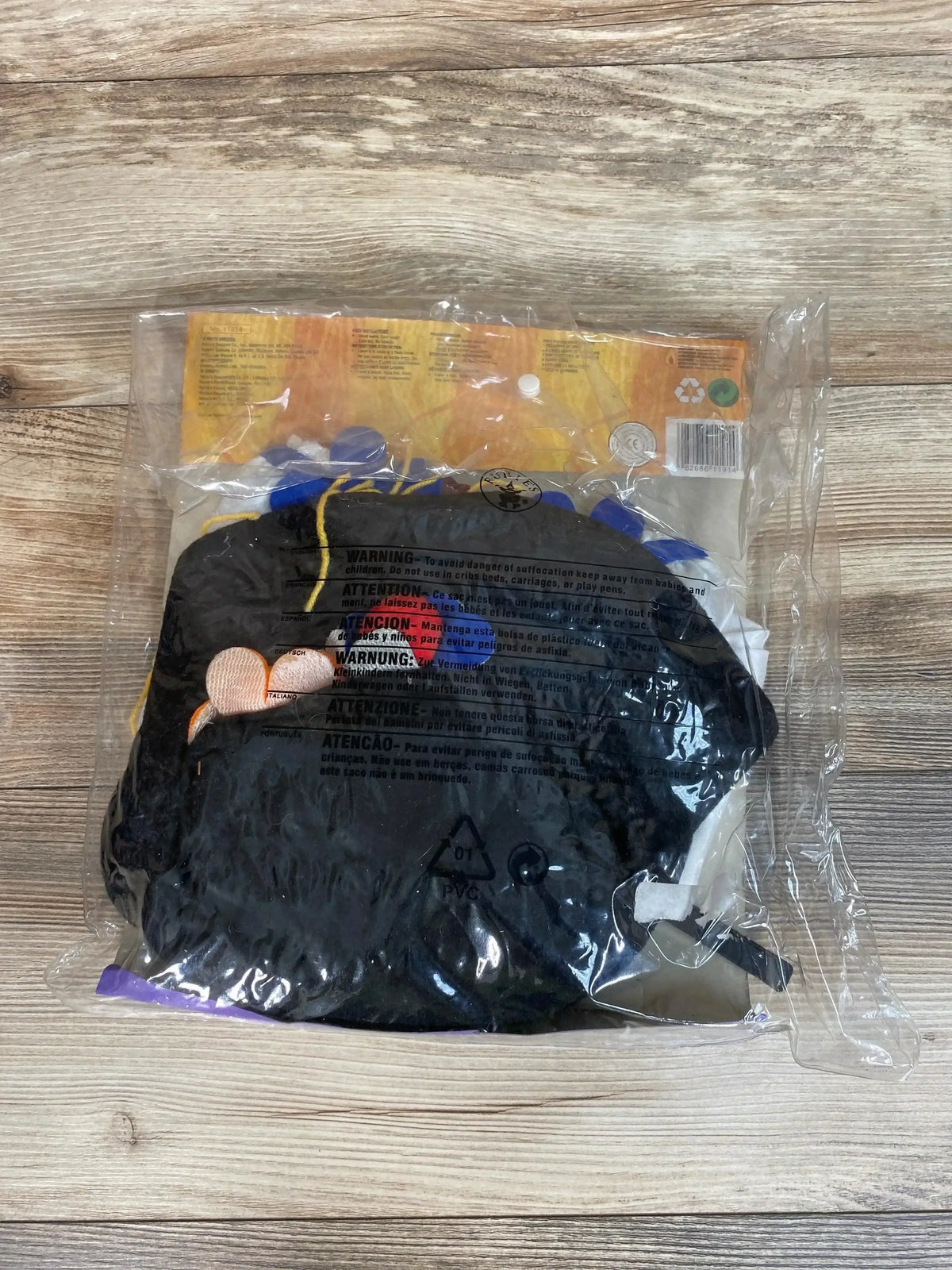 Packaged Rubie’s Yarn Babies Colorful Clown wig in black with blue, yellow, and purple yarn accents