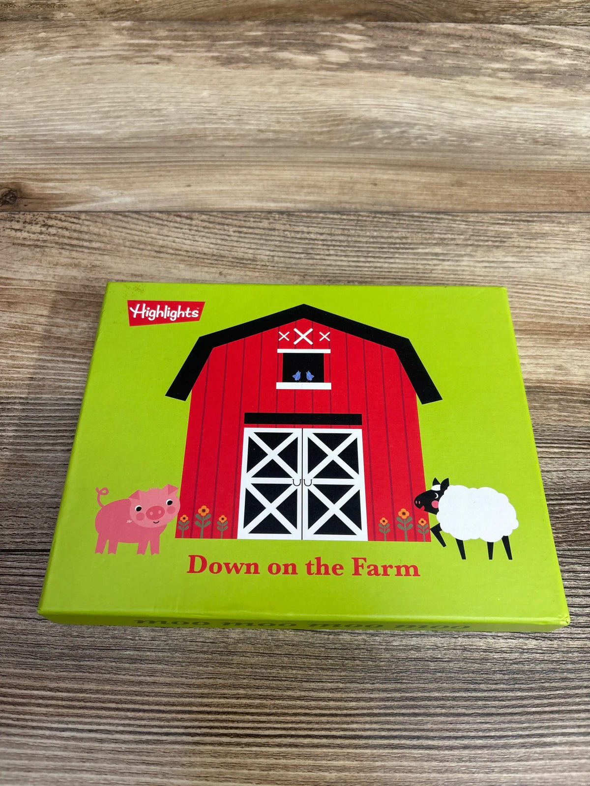 Children's farm-themed puzzle box with red barn, pig, sheep, and colorful flowers by Highlights