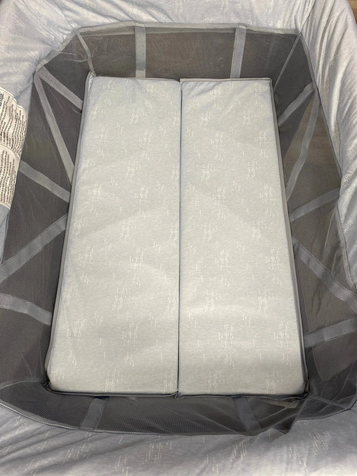 Top down view of Maxi-Cosi Swift Playard showing two-panel foldable mattress and mesh side panels on light gray interior