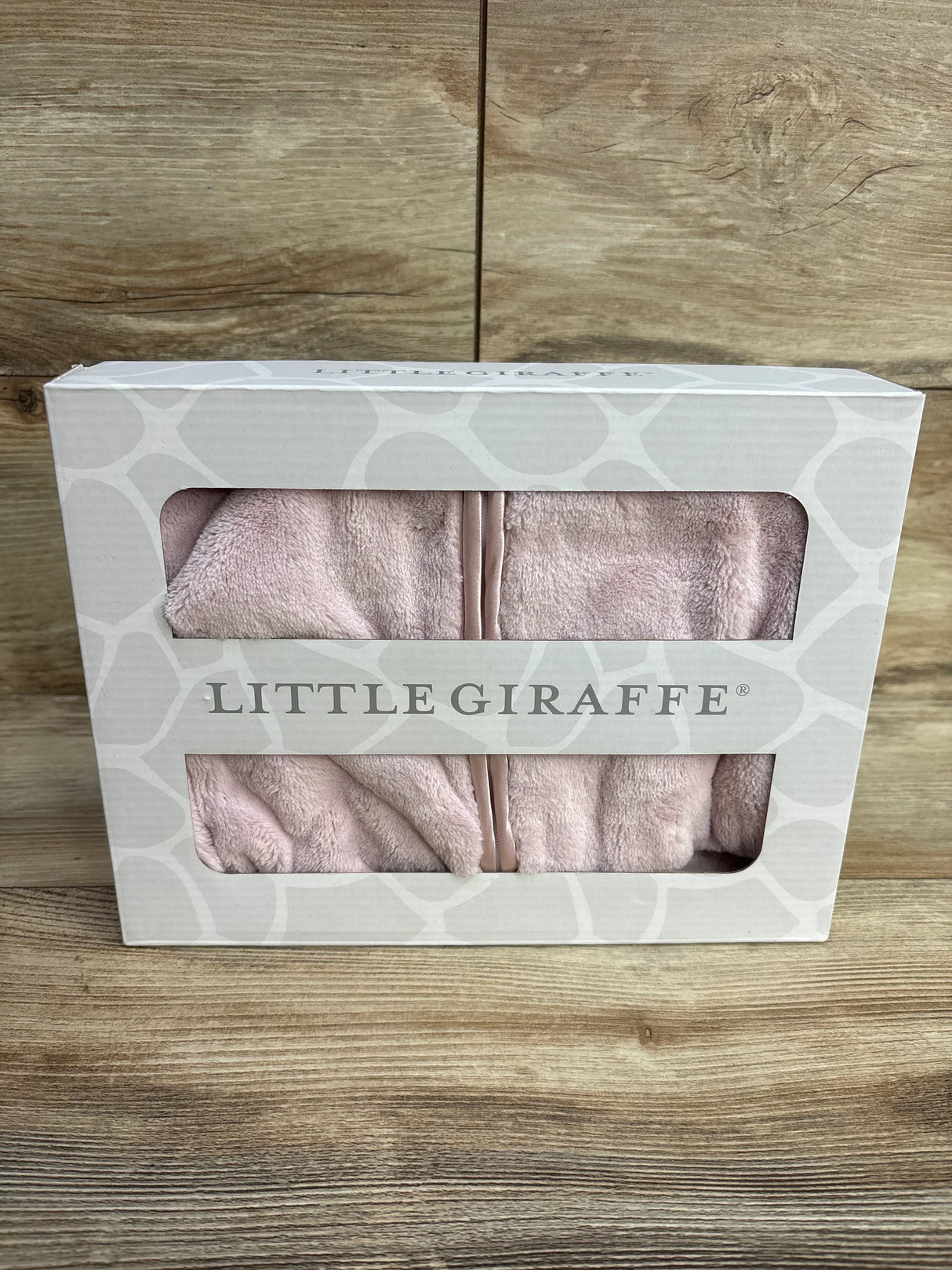 Little Giraffe pink plush baby blanket in gift box on wooden surface