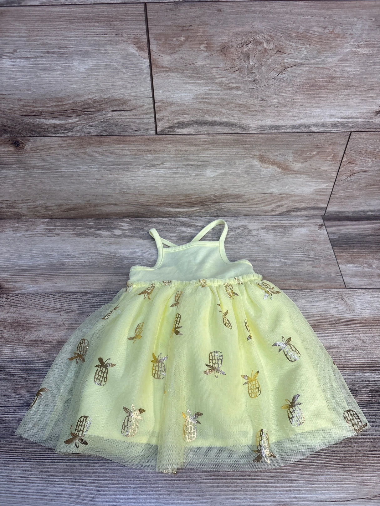 Light green baby dress with gold pineapple print and tulle skirt, perfect for summer outfits.