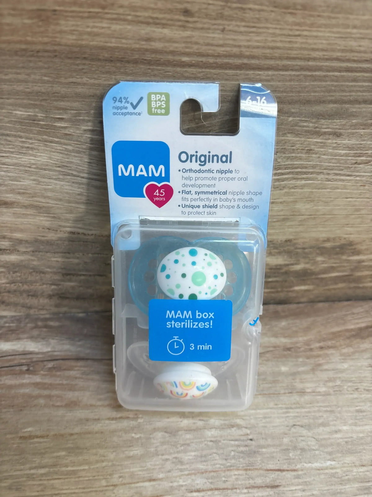 MAM Original orthodontic baby pacifiers in BPA free packaging on wood background