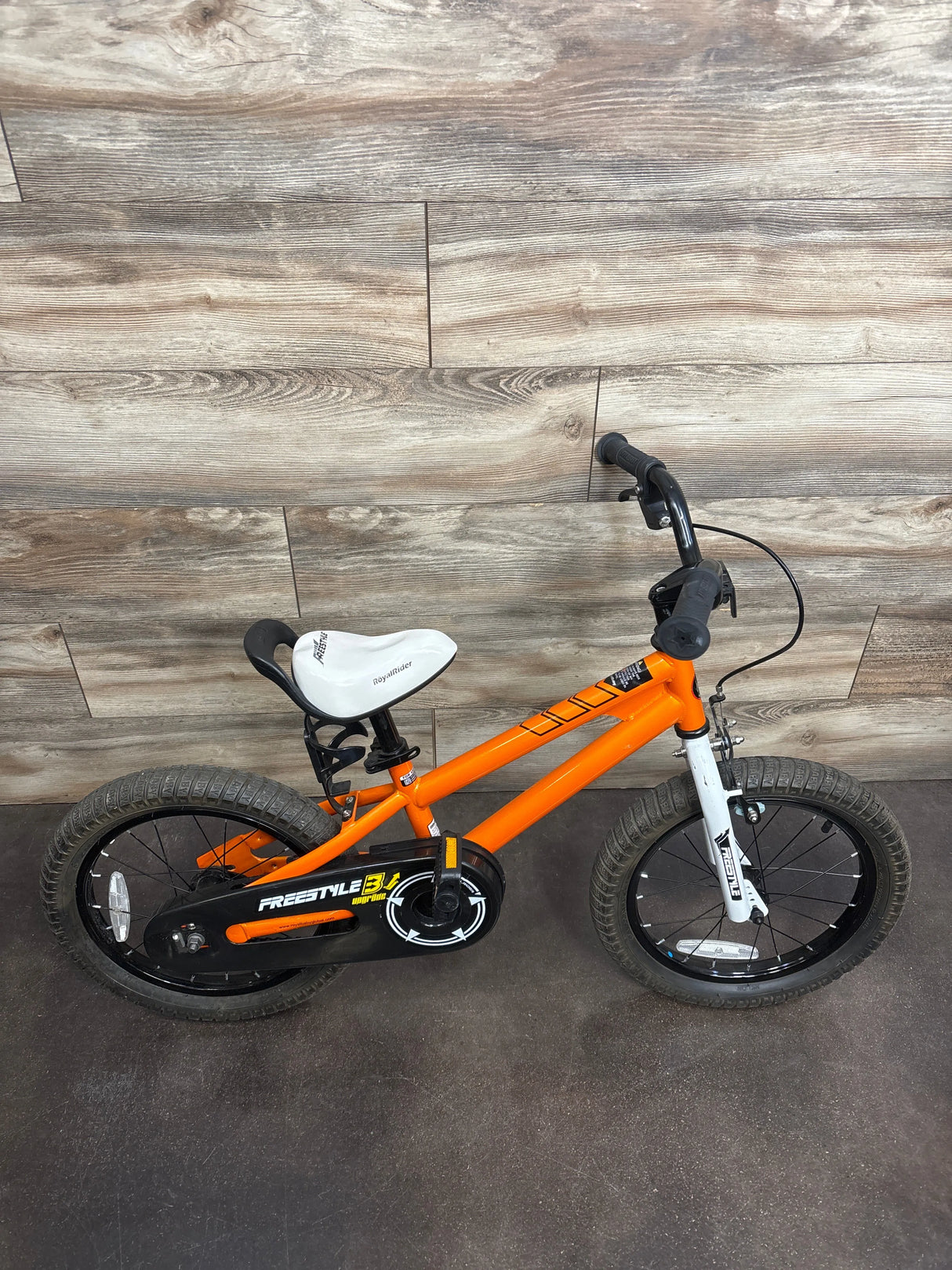 Orange RoyalRider kids bike with training wheels, ideal for toddlers learning to ride