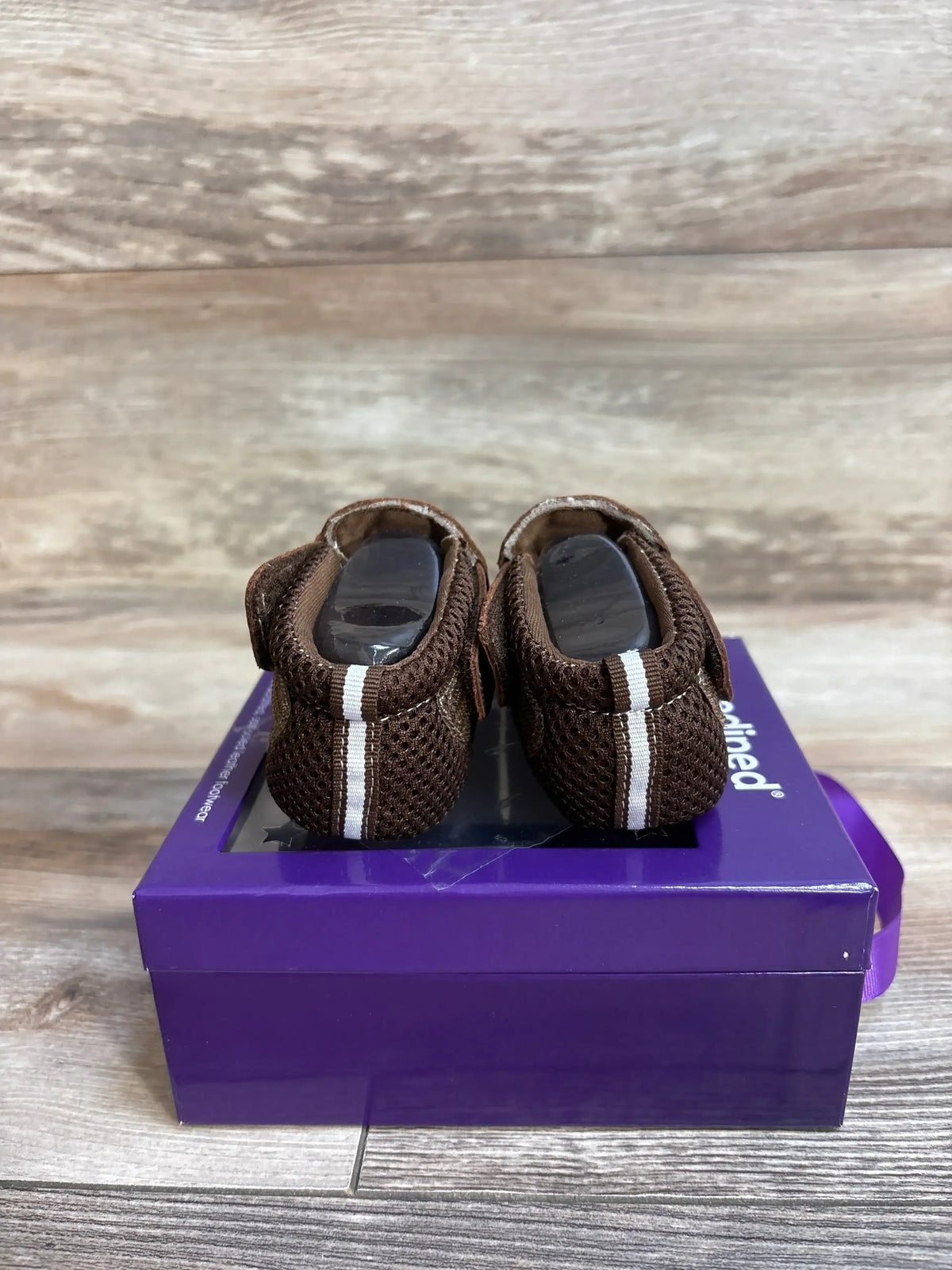 Rear view of Pediped Soft Sole Originals baby shoes size 5C showcasing brown mesh material and white center stripe on a purple shoebox