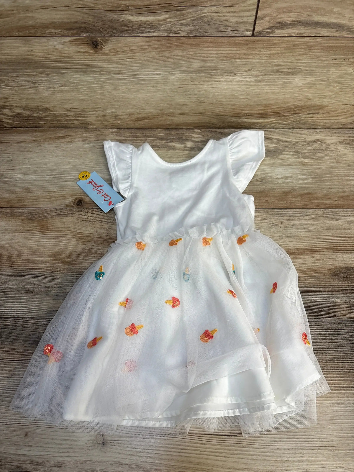 White toddler dress with ruffled sleeves and colorful ice cream embroidery on tulle skirt