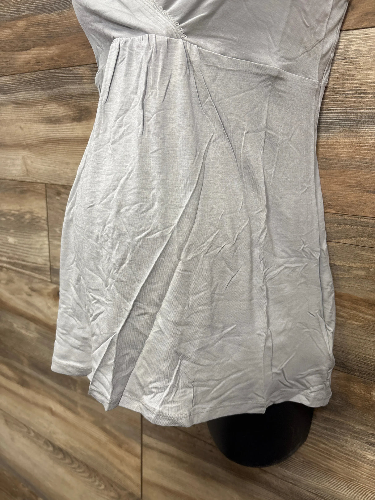 Light gray maternity dress with pleated skirt on wood background, gently used kids clothing