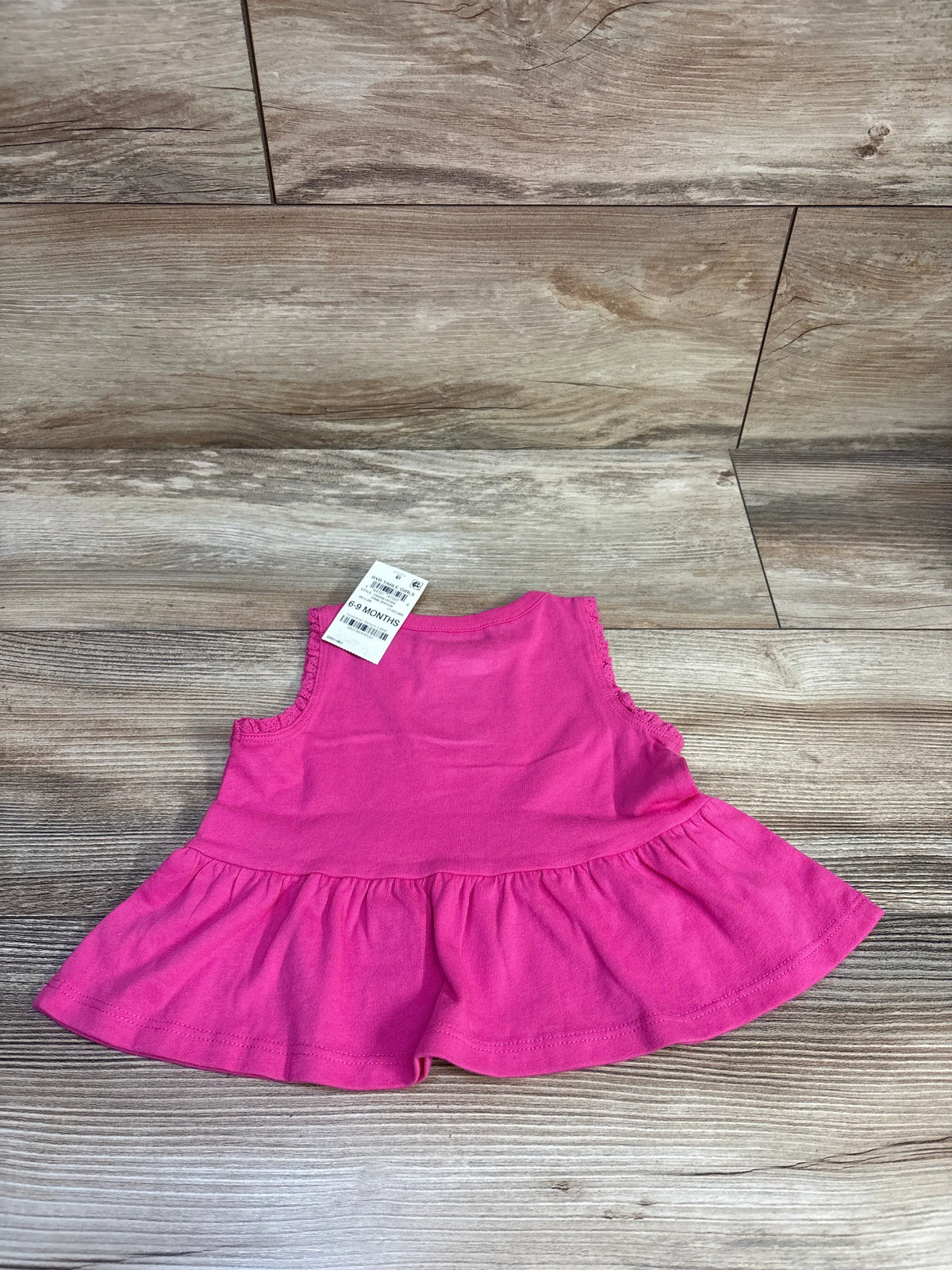 Front view of pink First Impressions peplum tank top, size 6 to 9 months, with sleeveless design and gathered hem