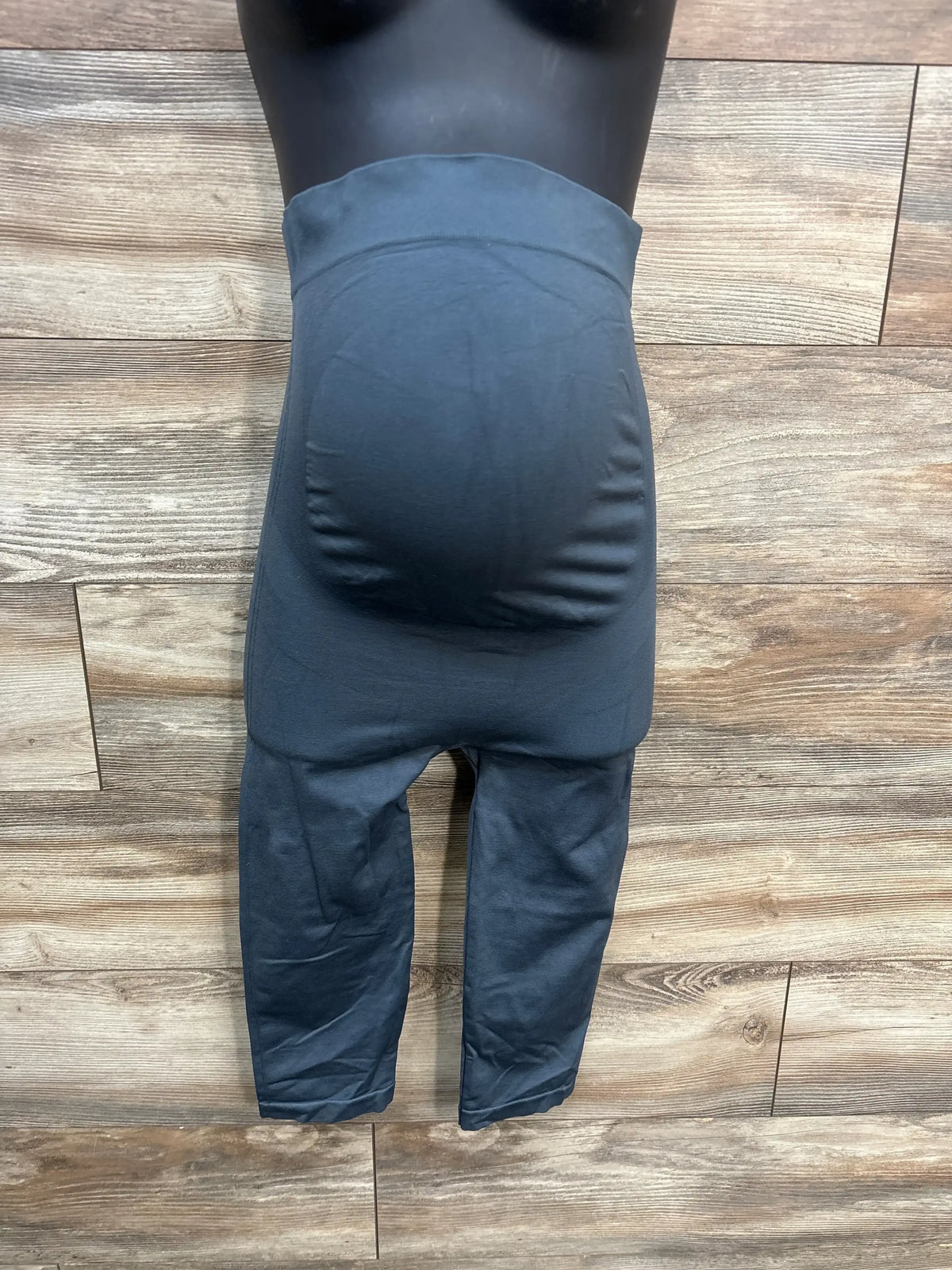 Front view of Blanqi maternity capri leggings in grey, size large, showing high-rise full-belly support panel on wood plank background