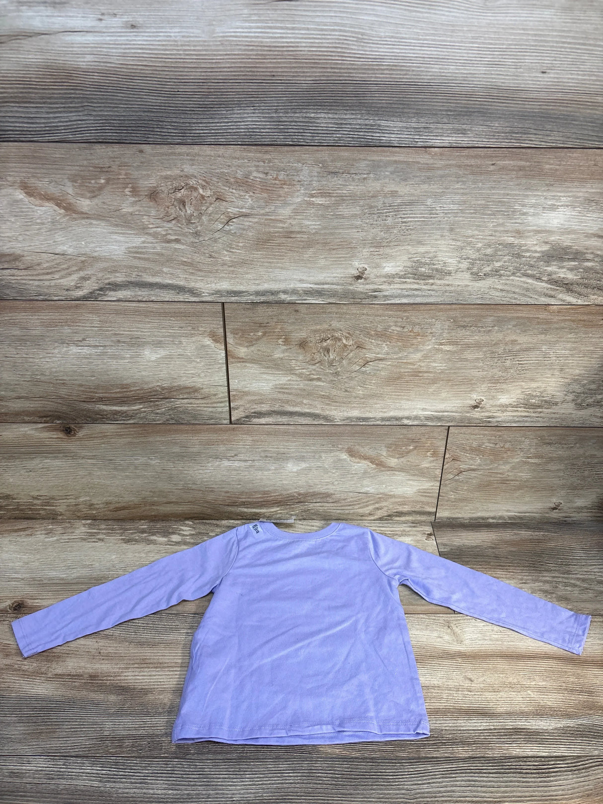 Back view of Children’s Place purple long-sleeve toddler shirt (2T) showing plain back and crew neckline, laid flat on wood floor