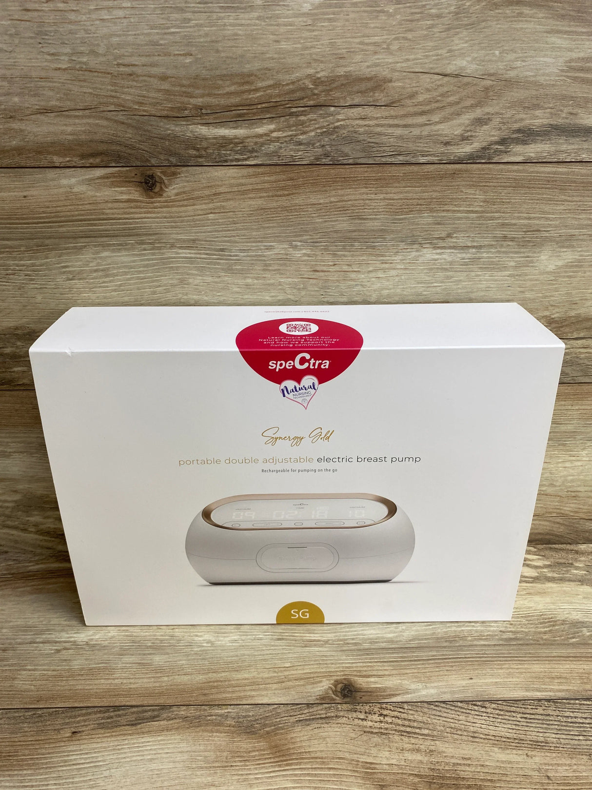 Spectra Synergy Gold portable double electric breast pump in box on wood background