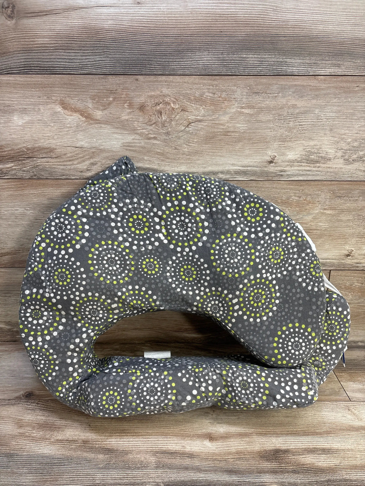 Front view of My Brest Friend nursing pillow slipcover showcasing its gray circular pattern on a wood background