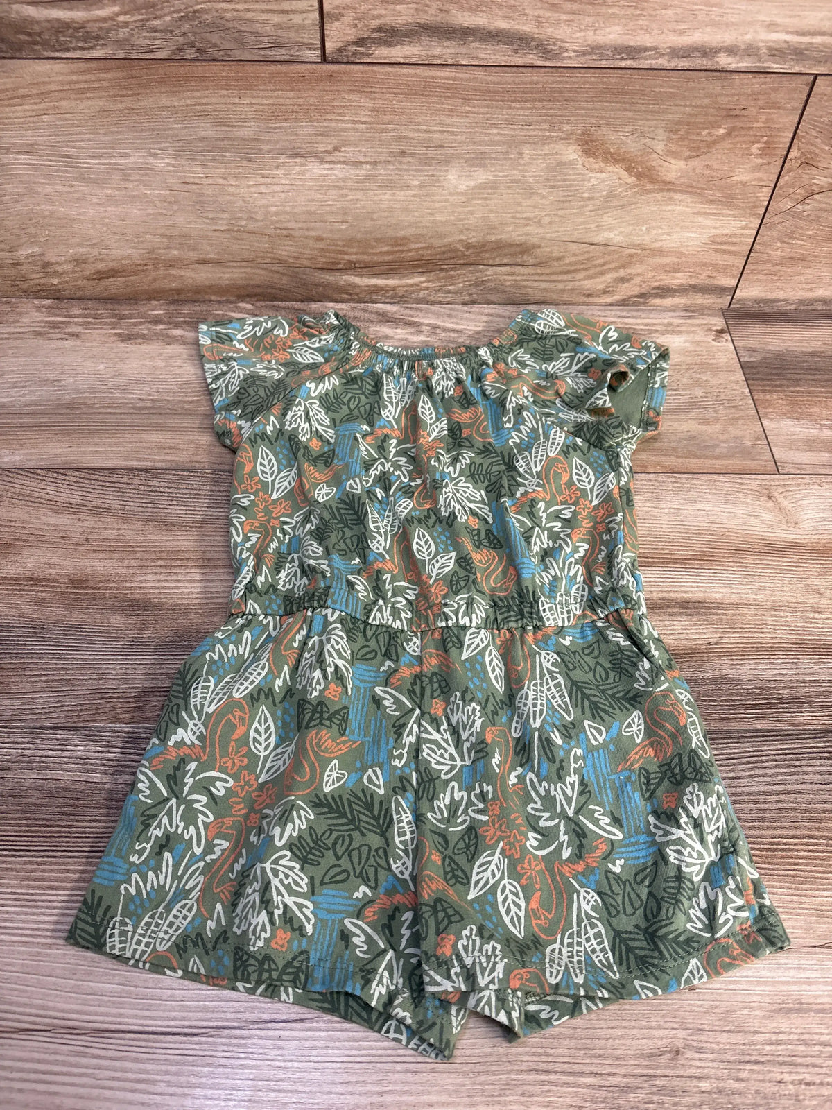 Front view of Joe Fresh green shortie romper in size 4T showcasing botanical print and fitted waist on wood background