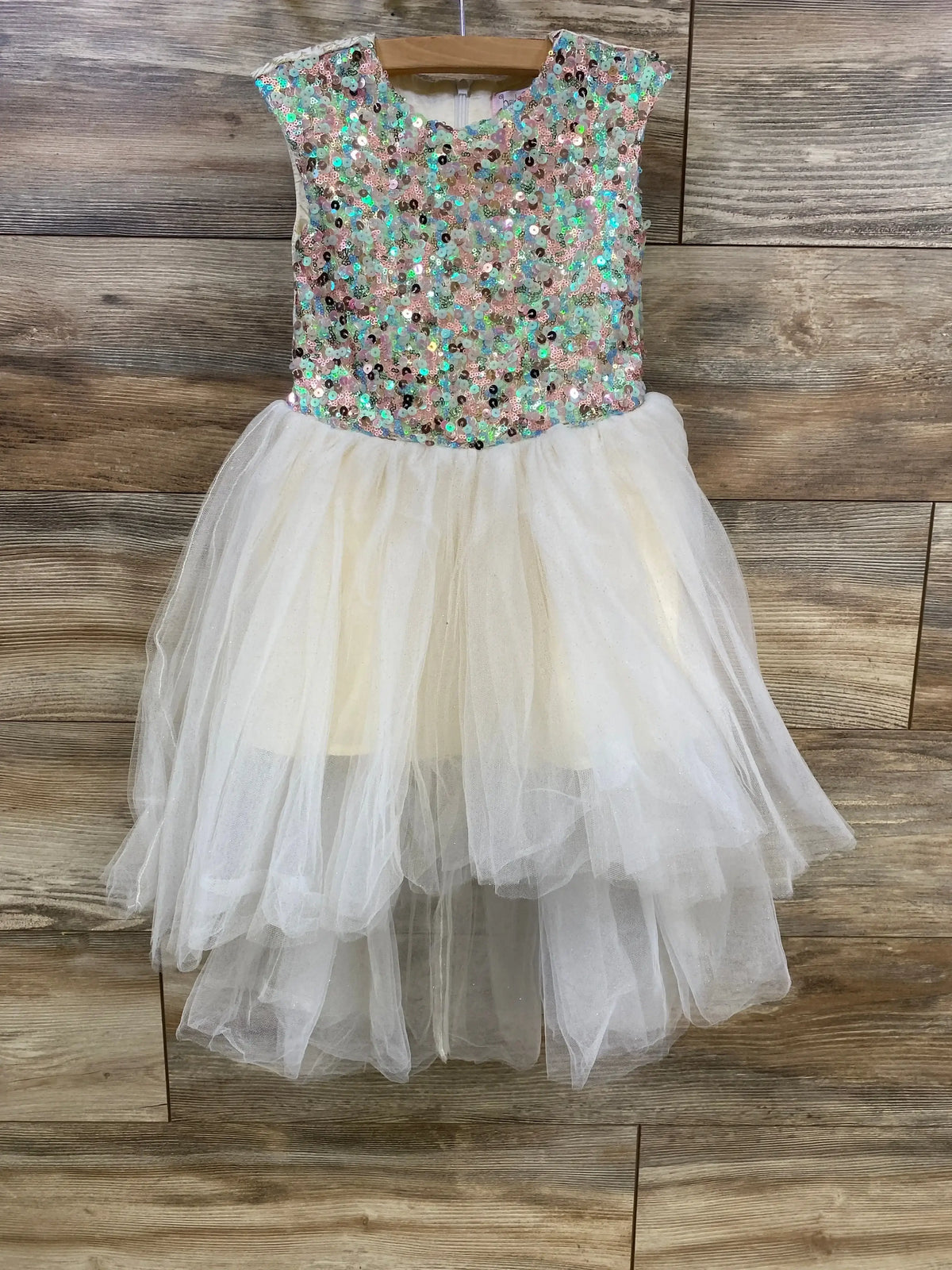 Front view of Halabaloo sequin tulle dress (2T) showing sequin bodice and layered ivory skirt on wood background