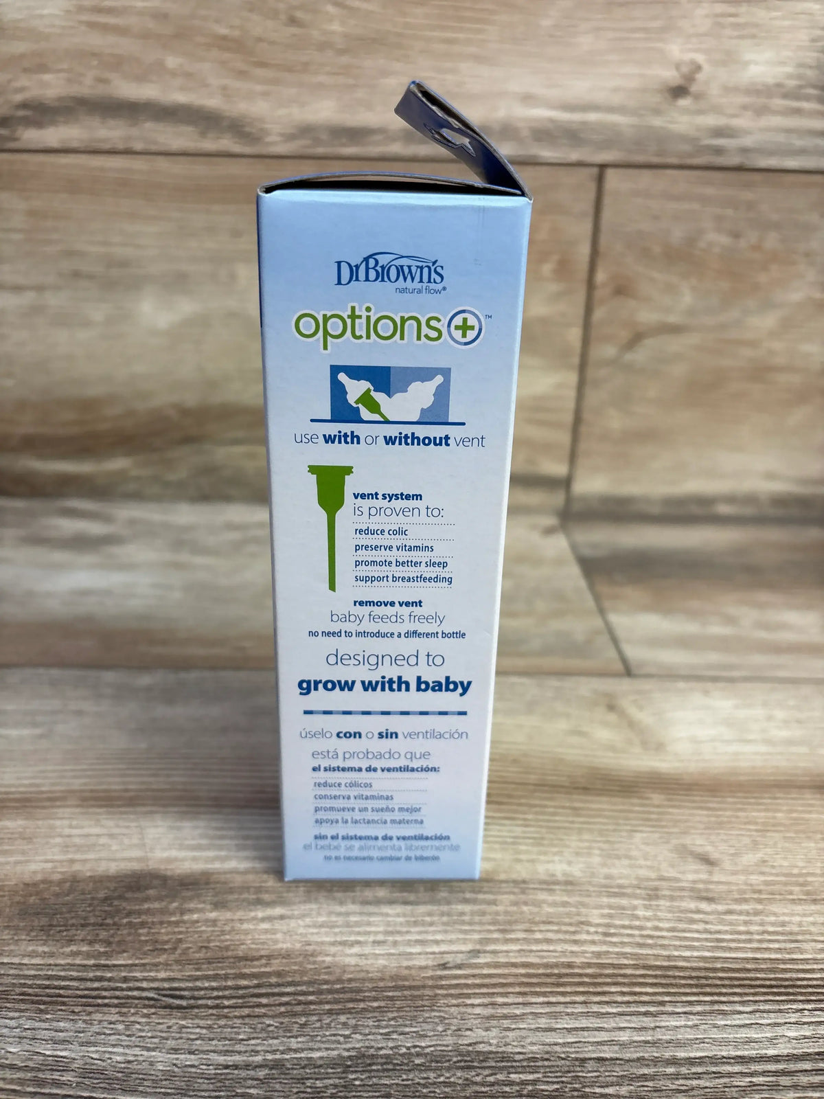 Side view of NEW Dr. Brown’s Narrow Baby Bottle packaging showcasing the Options+ vent system on a wood surface