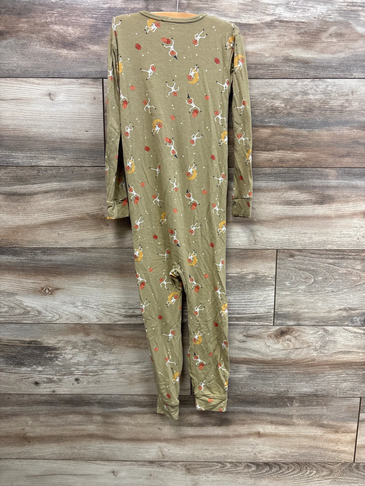 Front view of Modern Moments Halloween footless sleeper showcasing skeleton and pumpkin print on a wood floor