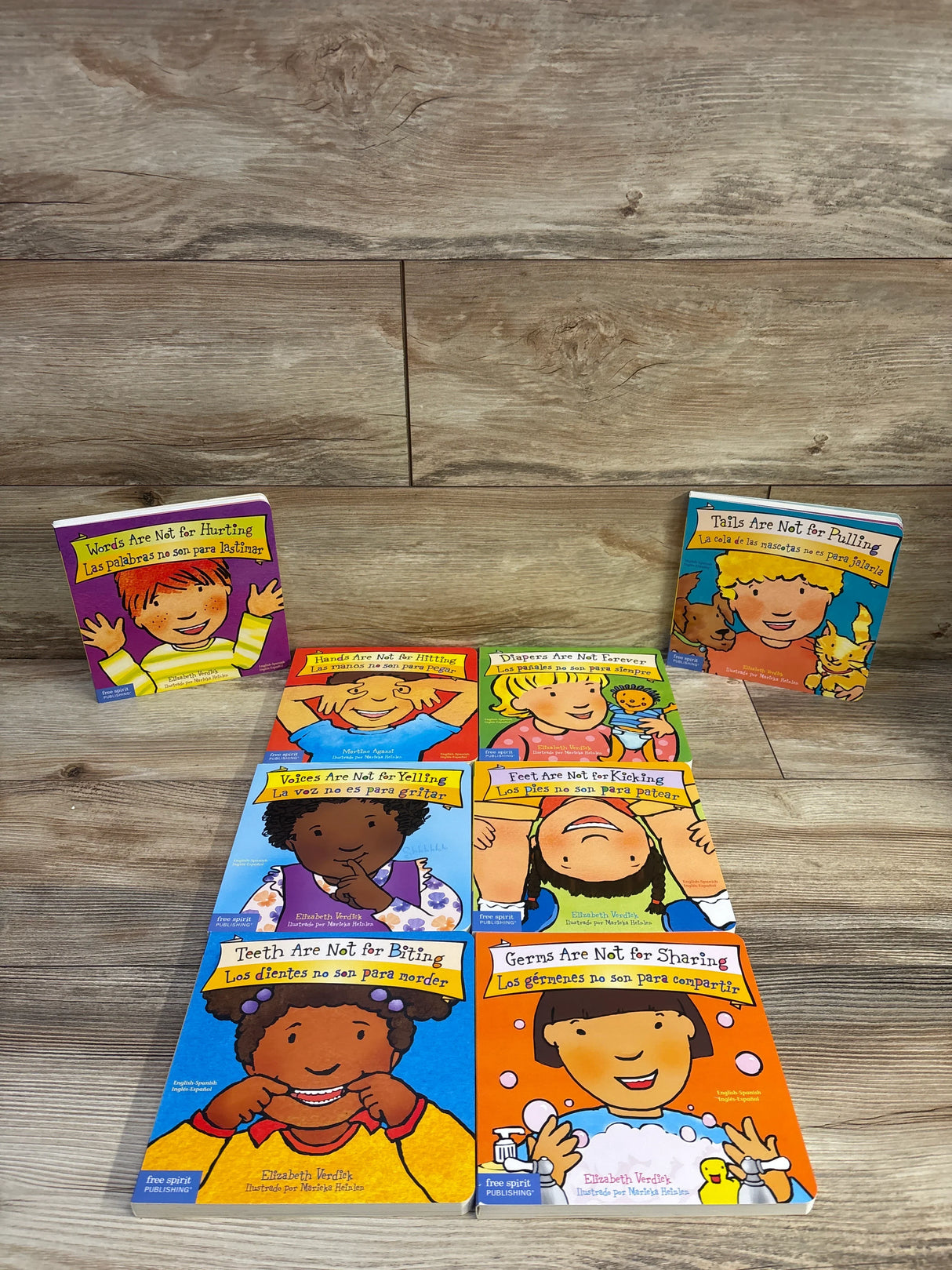 Front view of Lakeshore Best Behavior set of 8 board books showing colorful covers like ‘Words Are Not for Hurting’ on wood