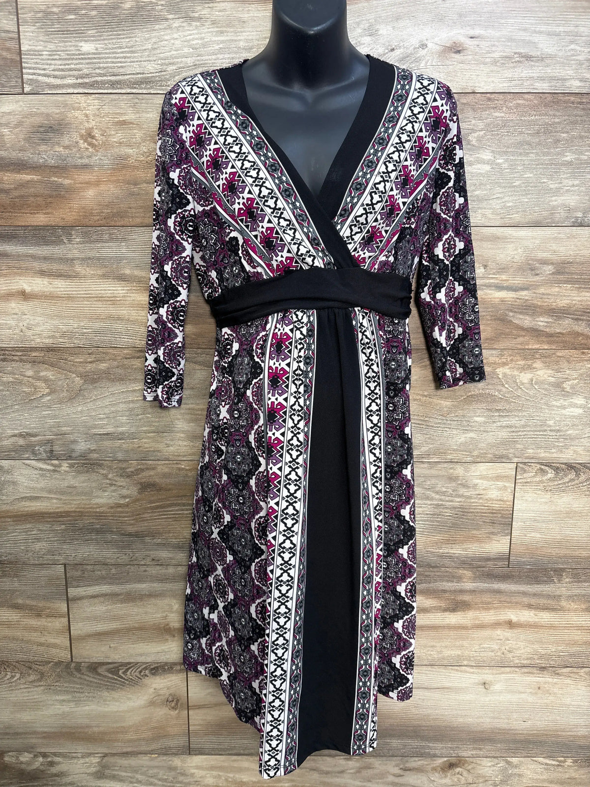 Front view of Motherhood Maternity purple geometric maternity dress with long sleeves and V-neck on mannequin