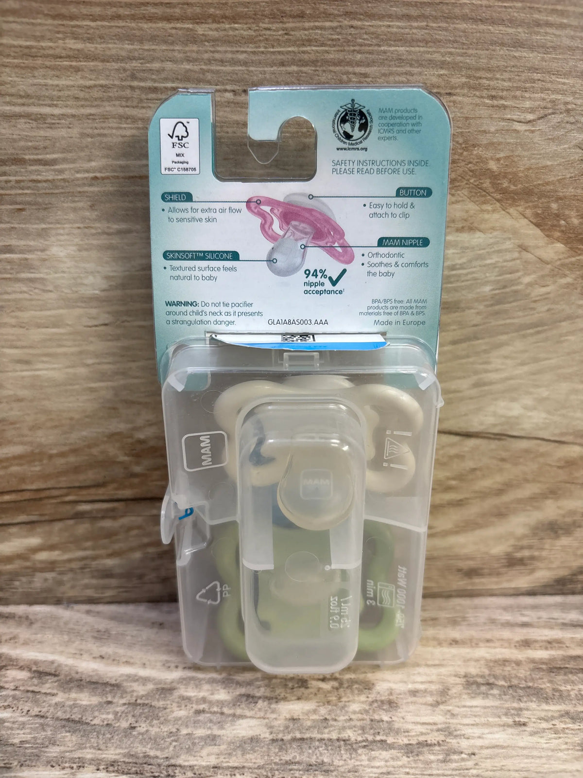 Back view of MAM Air two pack pacifiers in cream and green for ages zero to six months with clear storage case and packaging