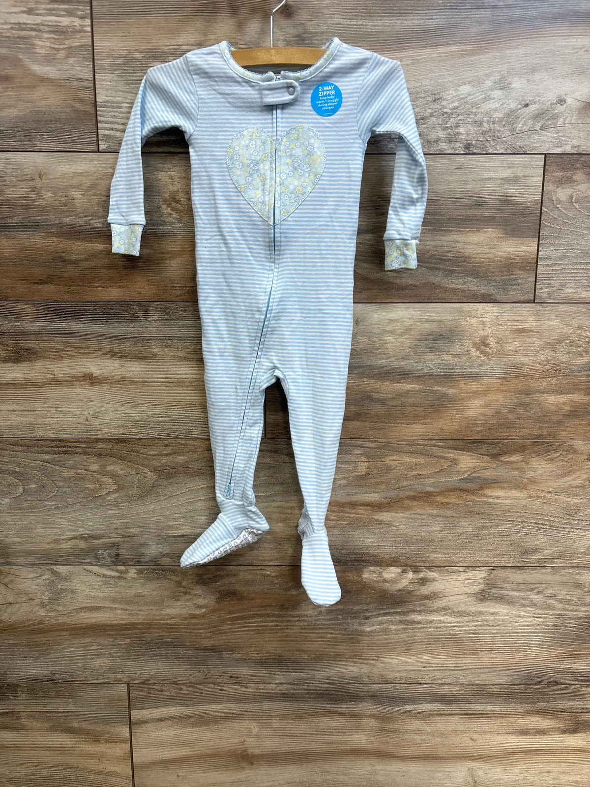 Carter's blue striped baby sleeper with a yellow floral heart on the chest