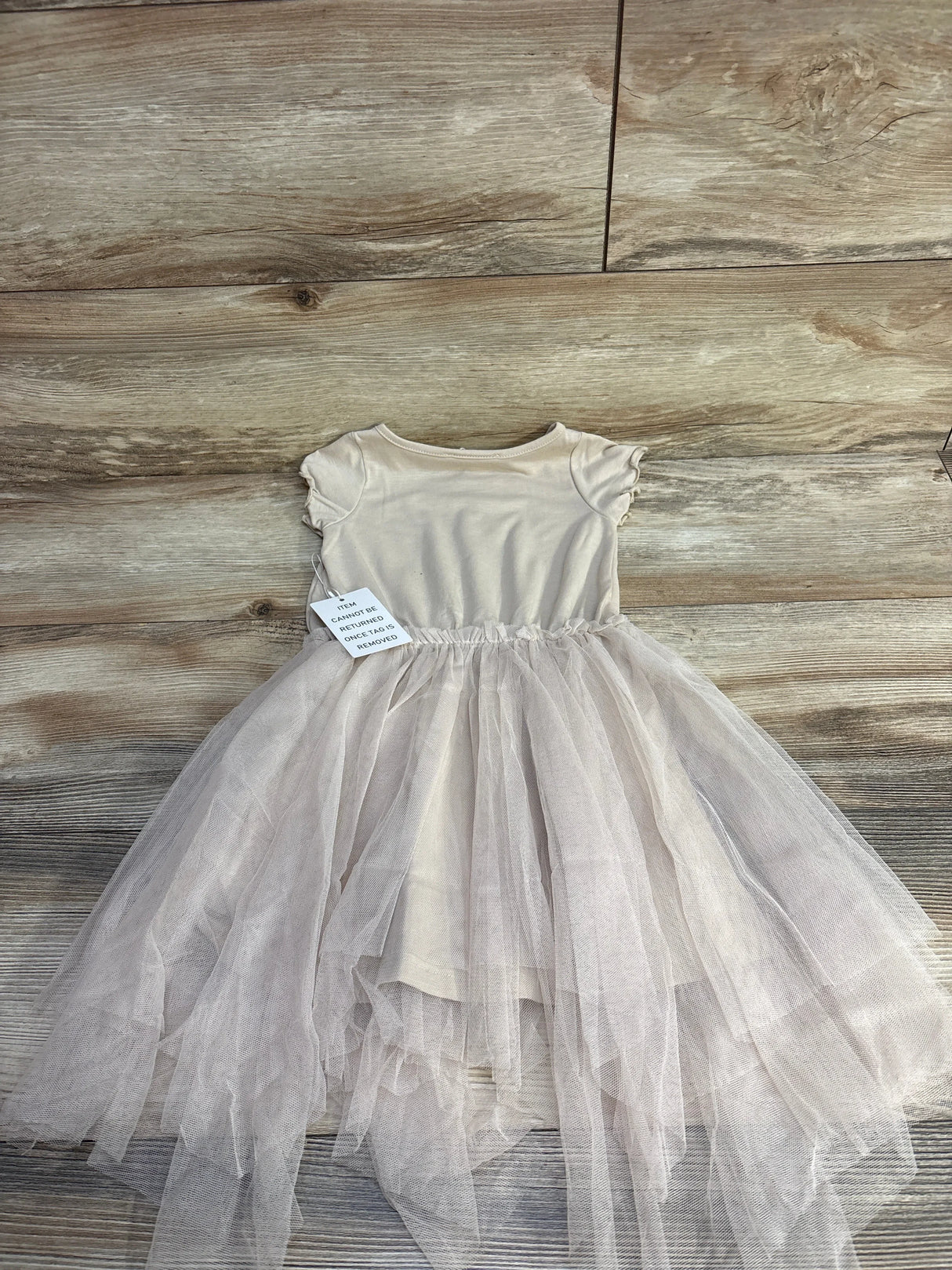 Front view of Mia Joy Feya toddler dress in sand showcasing Je T’aime Paris chest print and gathered skirt on white background