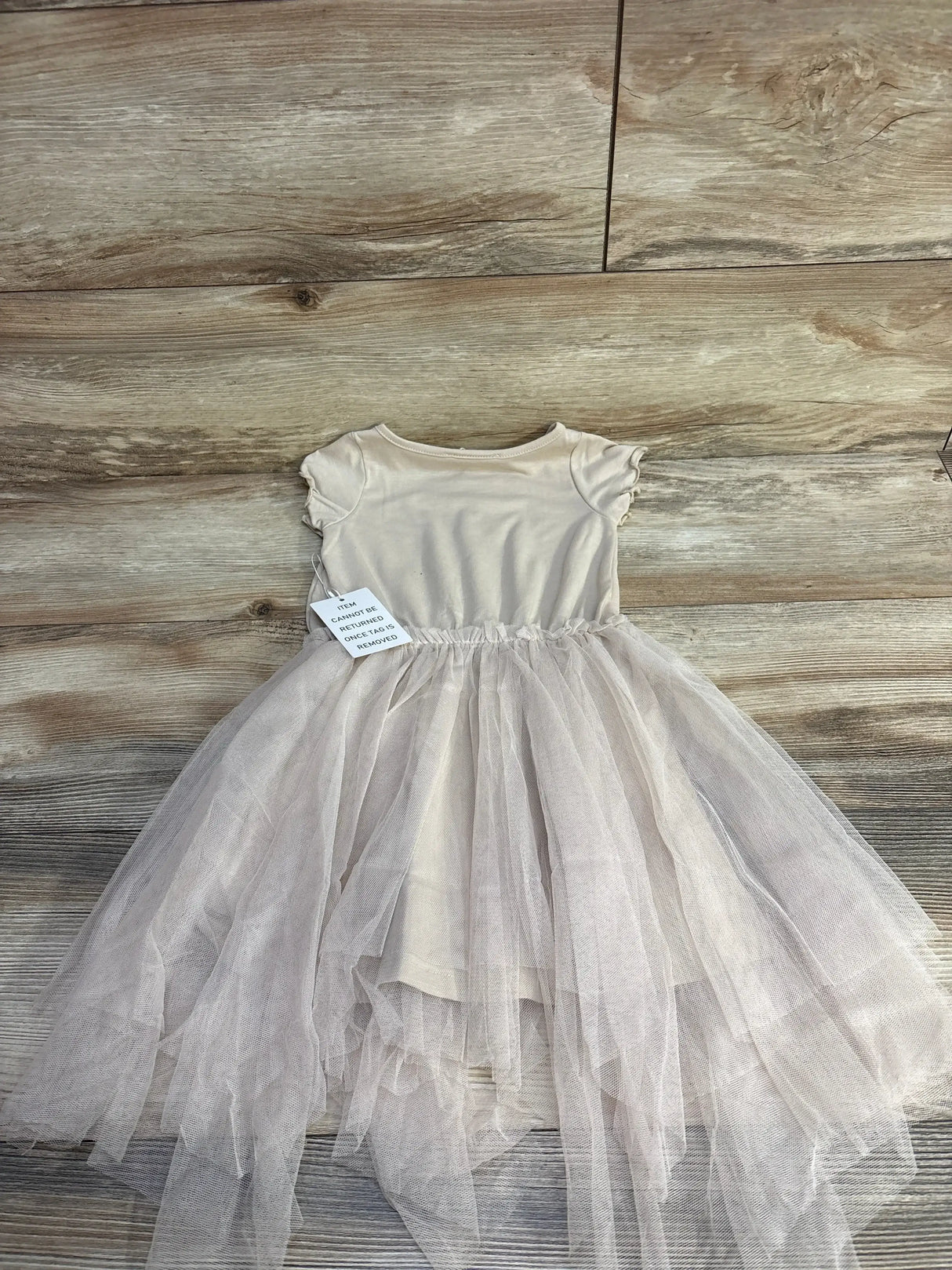 Front view of Mia Joy Feya toddler dress in sand showcasing Je T’aime Paris chest print and gathered skirt on white background