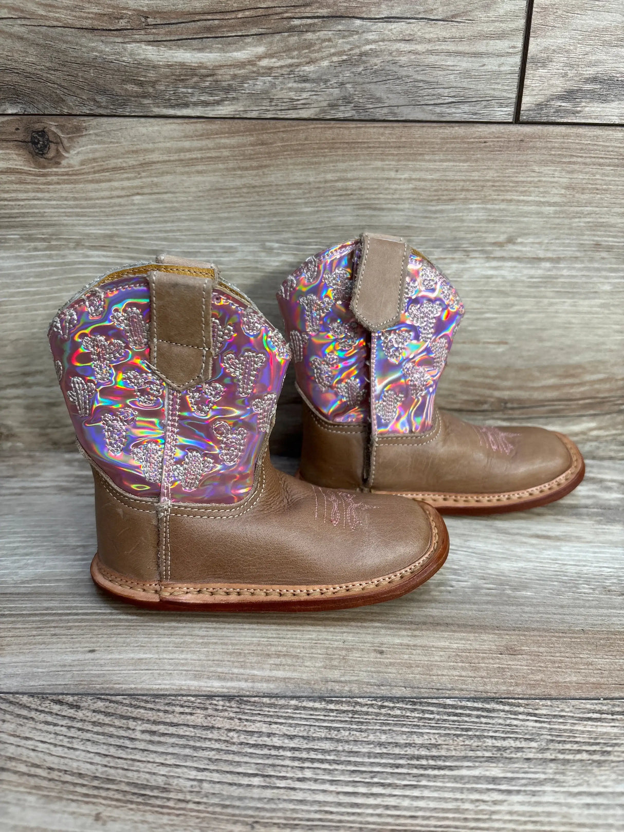 Side view of Roper Kids pink Looking Glass cowgirl boots showing sparkly shaft stitching and low heel on white background